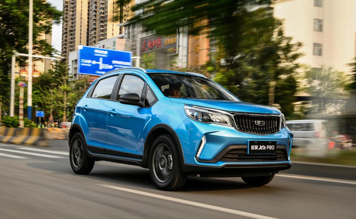 Blue compact SUV driving on a city street with motion blur.