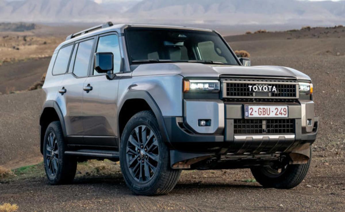A rugged silver Toyota SUV parked on a rocky terrain under a cloudy sky.