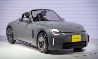 Sleek modern convertible car with rounded headlights and minimalist design.