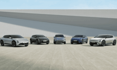 Five modern SUVs lined up outdoors under a clear sky.
