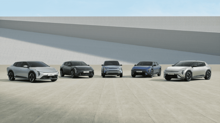 Five modern SUVs lined up outdoors under a clear sky.