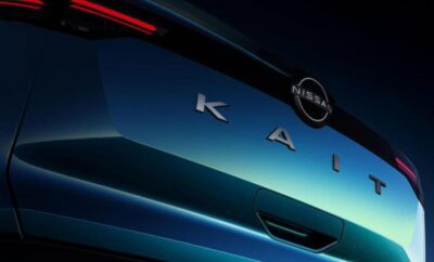 Close-up of a blue Nissan KAI car badge on the rear.