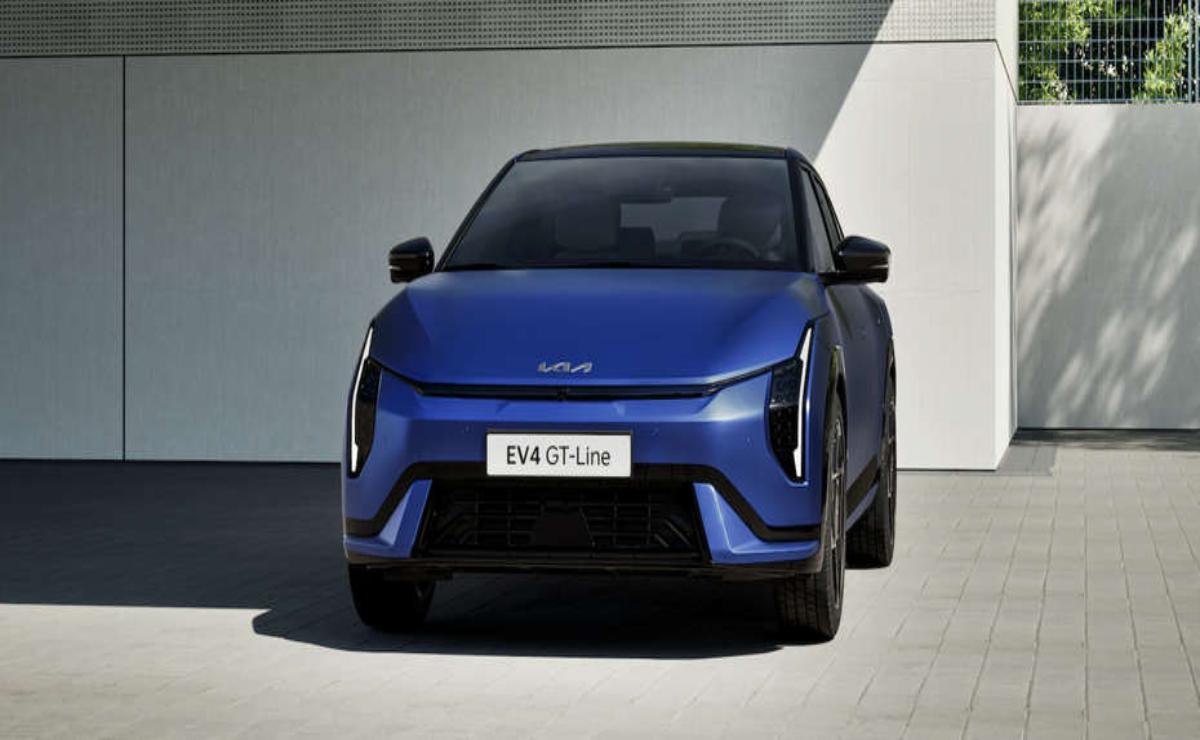Front view of a sleek blue electric vehicle under soft lighting.