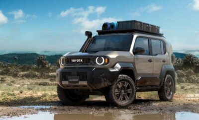 A rugged Toyota SUV parked on muddy terrain with a scenic mountain backdrop.