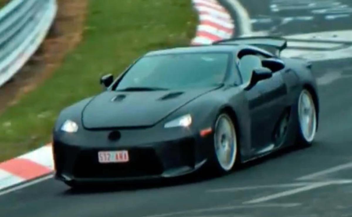 A sleek black sports car racing on a curvy track.