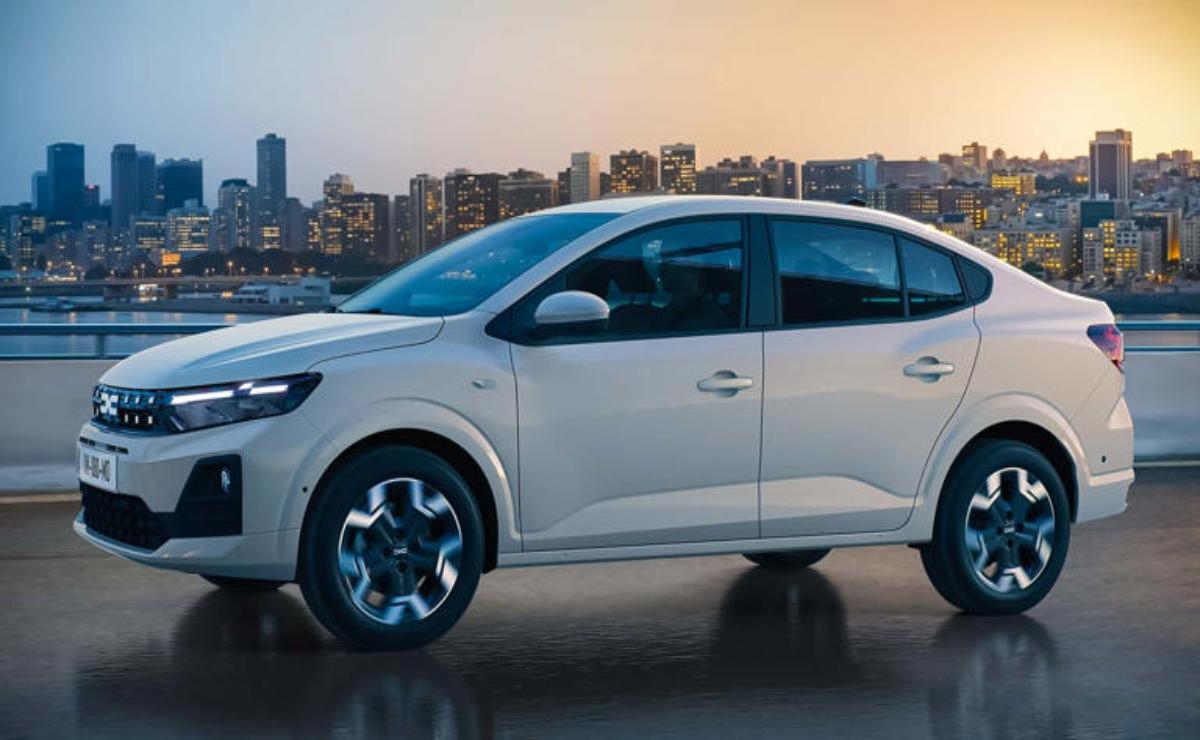A white compact car parked by a waterfront with a city skyline in the background.