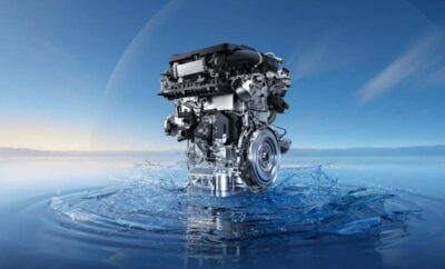 A modern engine floating on water under a clear sky.