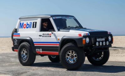 Off-road vehicle with Mobil 1 and Nismo branding on rugged terrain.