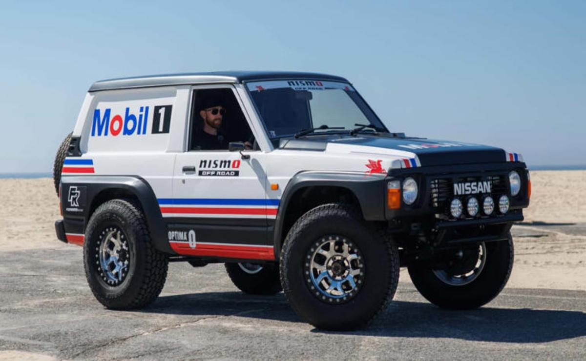 Off-road vehicle with Mobil 1 and Nismo branding on rugged terrain.