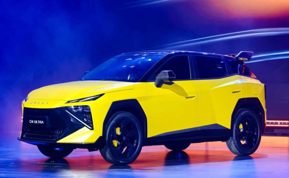 A sleek yellow electric SUV showcased on stage with dynamic lighting.