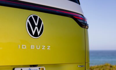 Rear view of a yellow VW ID Buzz electric vehicle with the logo and model name.