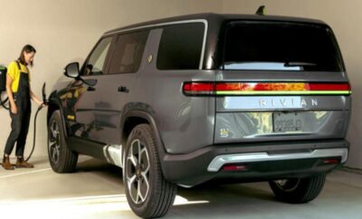 A sleek gray electric SUV parked indoors with modern design elements.