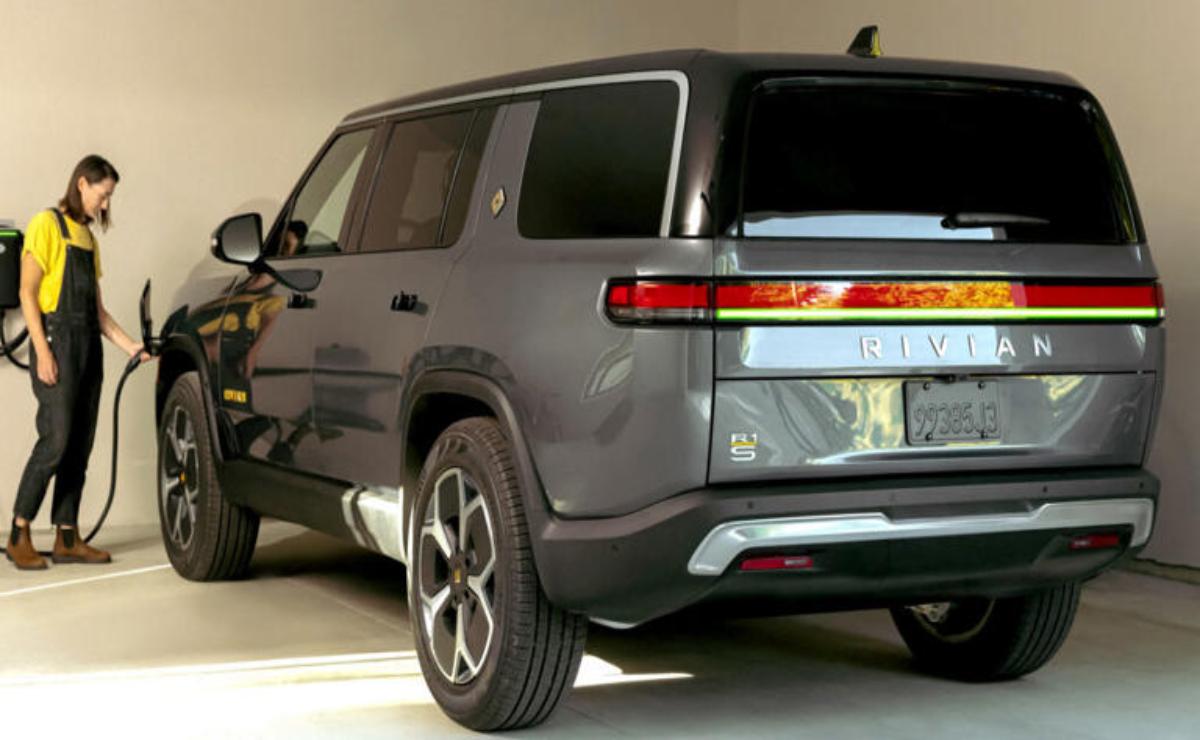 A sleek gray electric SUV parked indoors with modern design elements.