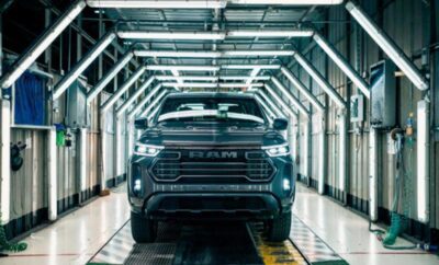 A black Ram pickup truck in a futuristic industrial setting.