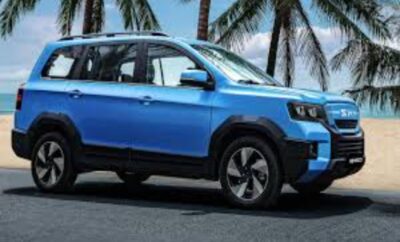 A blue compact SUV parked near palm trees on a sunny day.