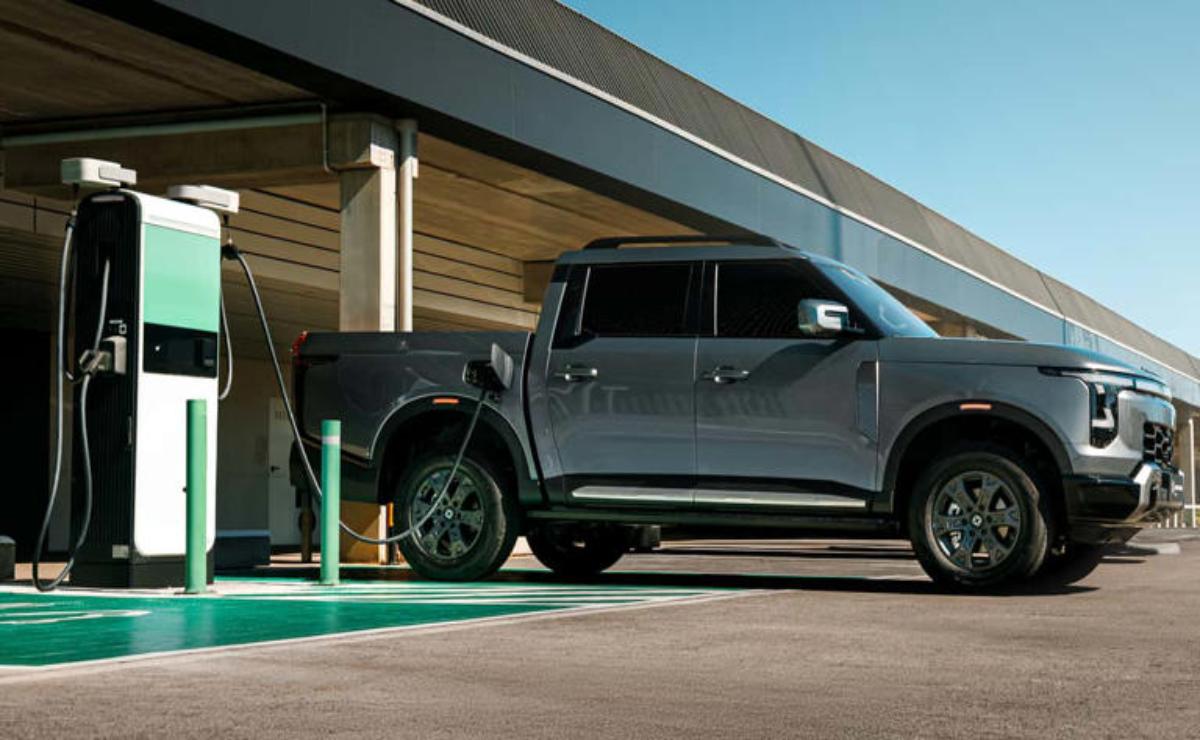 A gray pickup truck parked at an electric vehicle charging station.