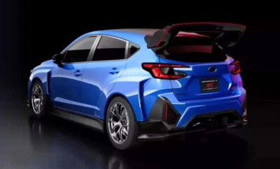 A sleek blue hatchback car with its rear hatch open, showcased in a dark setting.
