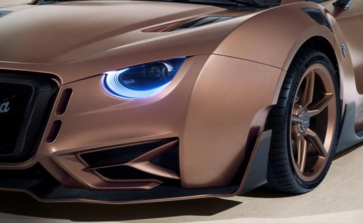 Close-up of a sleek car's futuristic headlight and aerodynamic front design.