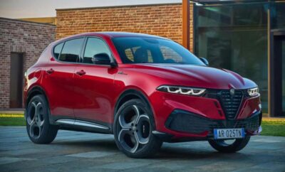 Sleek red electric SUV parked outside a modern building.