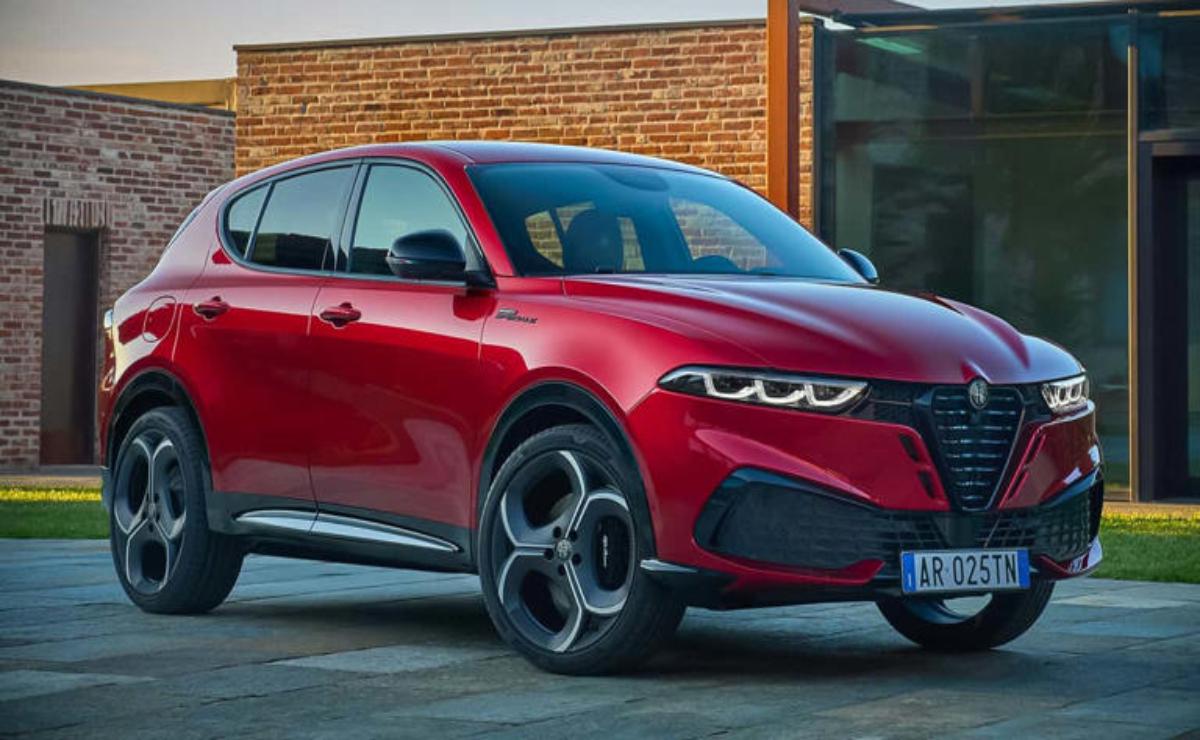 Sleek red electric SUV parked outside a modern building.