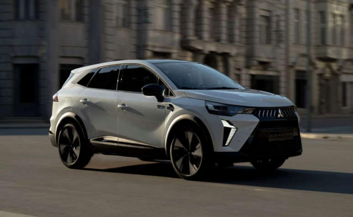 A sleek silver SUV driving through a city street.