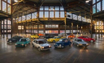 A vintage car exhibition inside a spacious, well-lit industrial building.