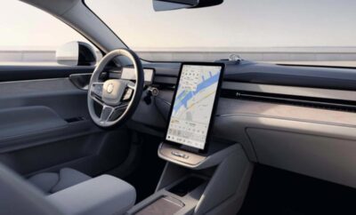 Modern car interior with large vertical touchscreen display and sleek dashboard.