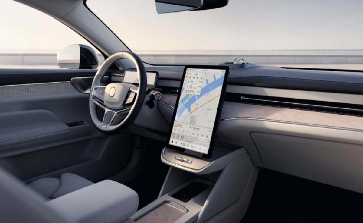 Modern car interior with large vertical touchscreen display and sleek dashboard.