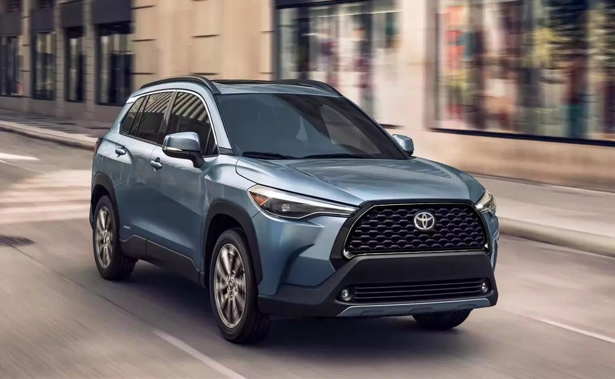 A blue Toyota SUV driving on a city street.