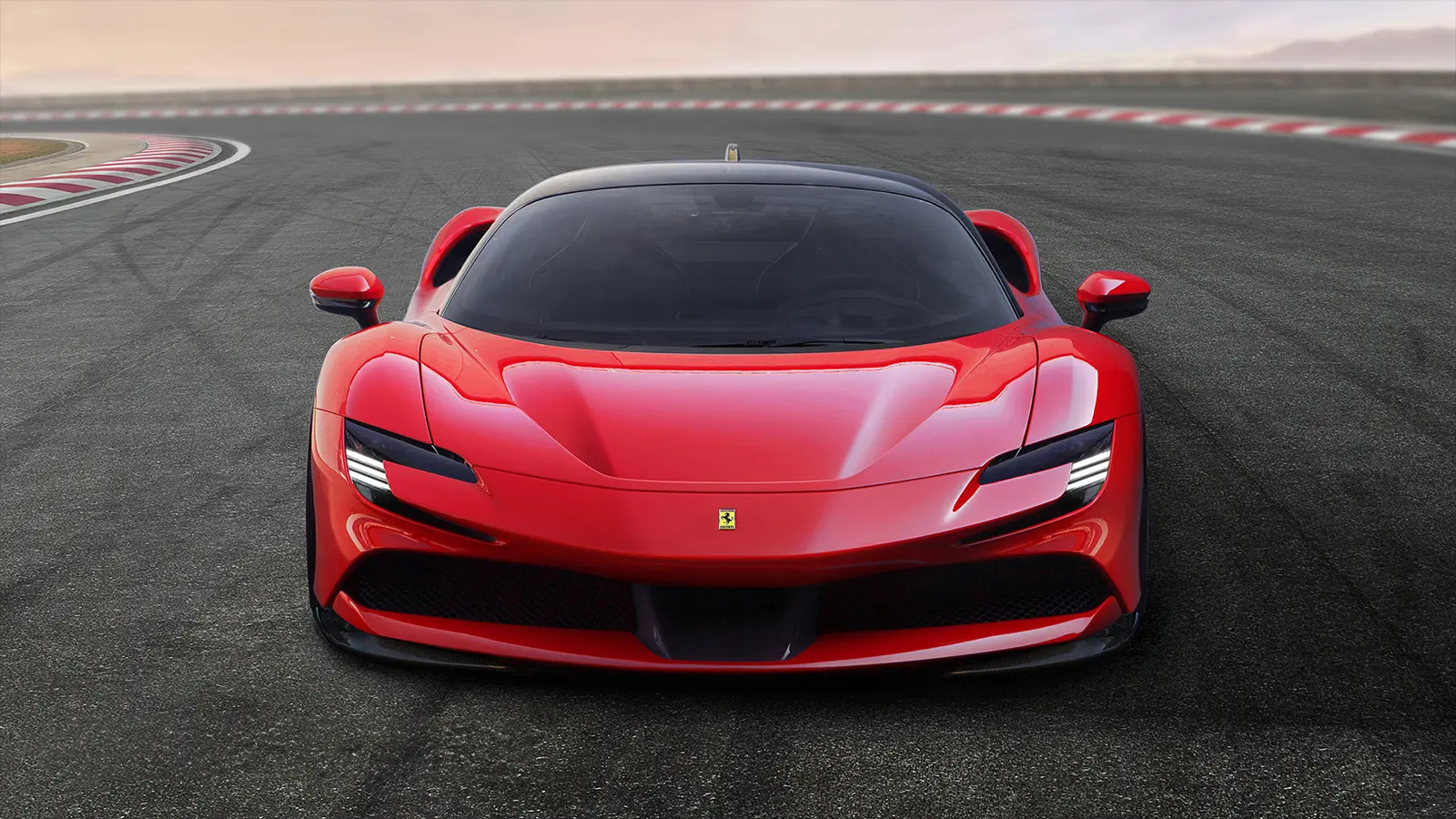 A sleek red Ferrari sports car on a race track.