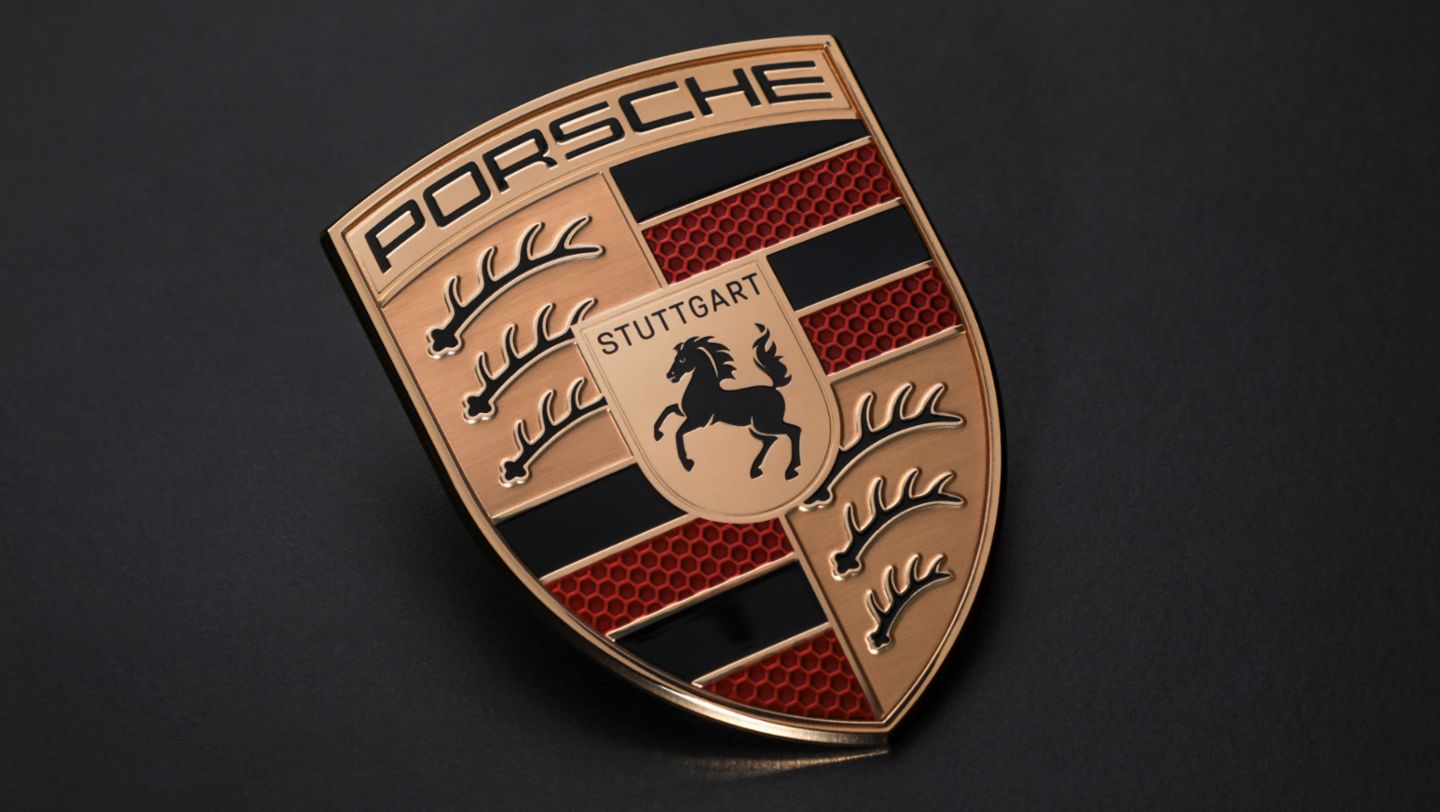 Close-up of a Porsche emblem with black and red stripes and a horse in the center.