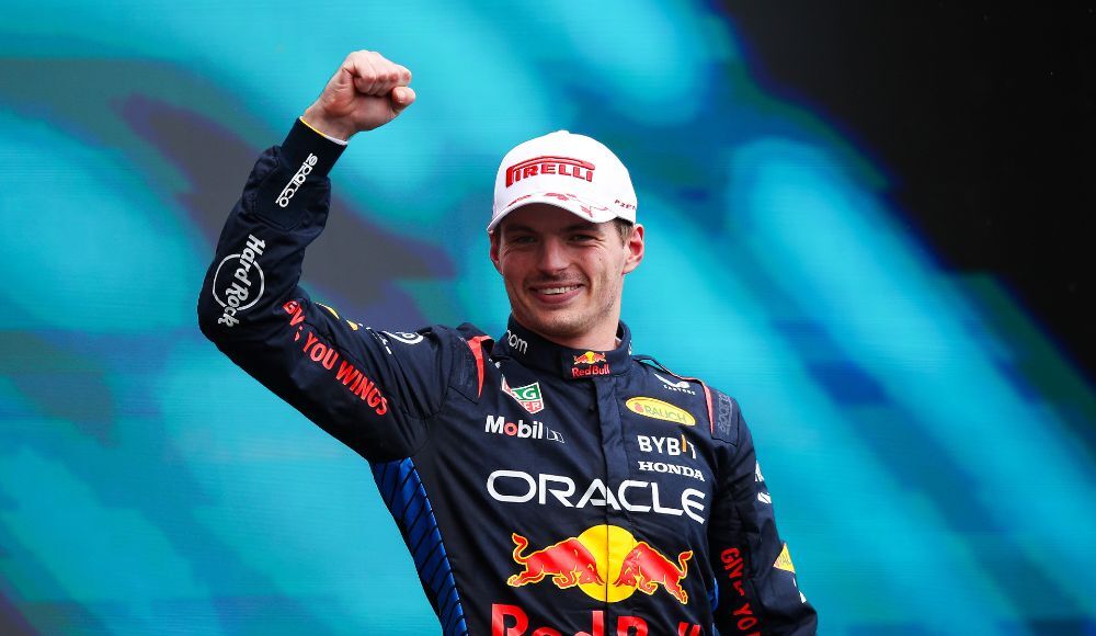 Race car driver celebrating a victory with a fist pump.