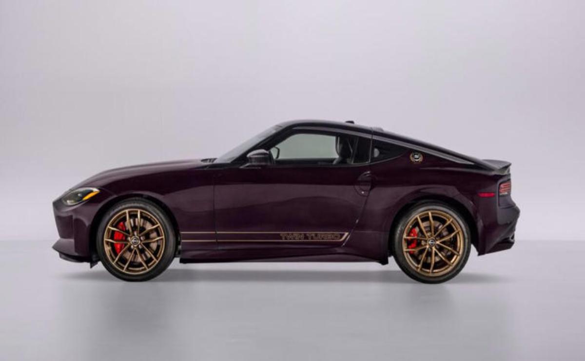 Side profile of a sleek dark purple sports car with bronze wheels.