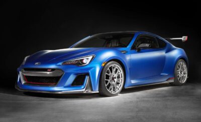 A sleek blue sports car with stylish silver rims on a dark background.