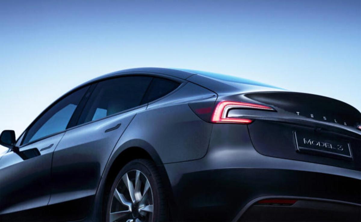 Sleek electric car with modern design and glowing taillights at dusk.