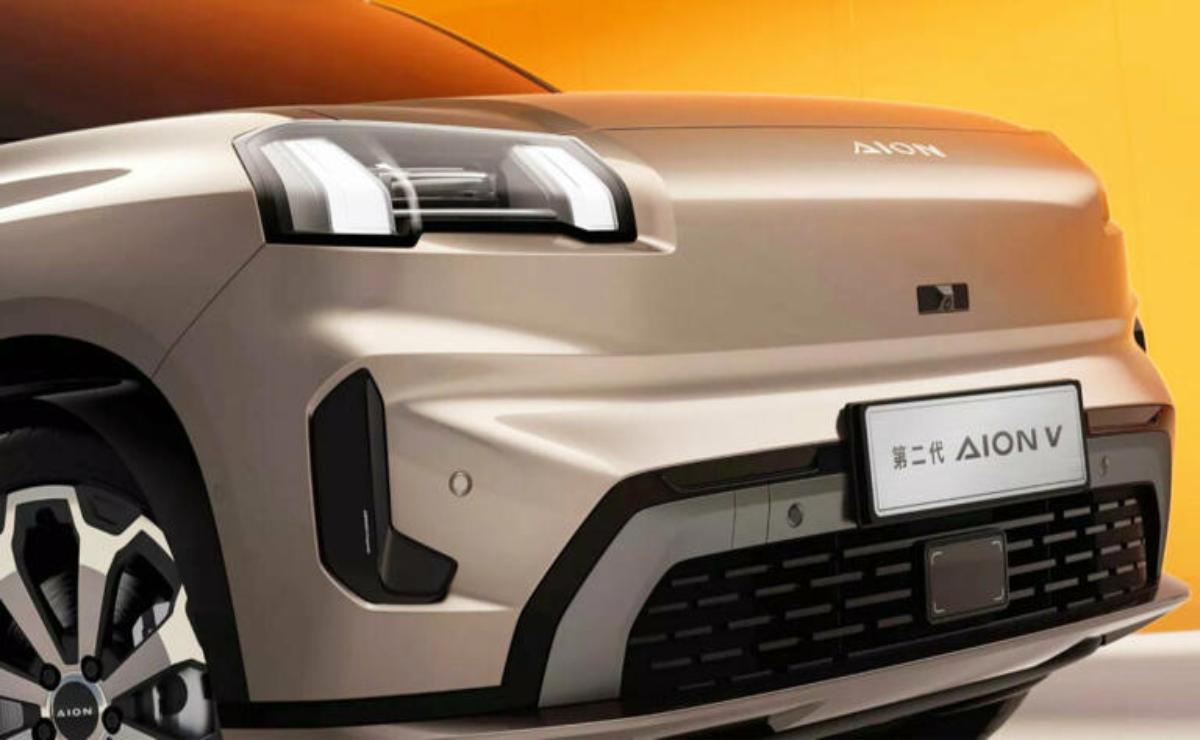 Front view of a modern electric SUV with sleek headlights and a smooth beige finish.