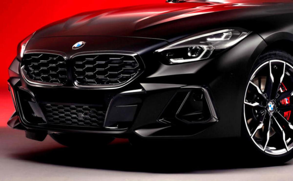 Close-up of a sleek black BMW with striking red accents and sharp headlights.