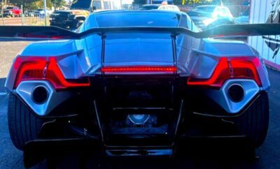 Rear view of a futuristic sports car with sleek angular taillights.