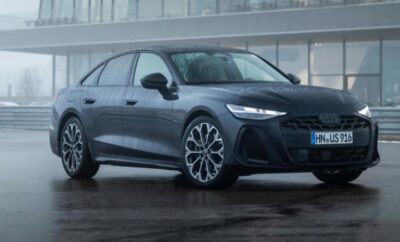 A sleek gray Audi electric car parked on a wet surface.