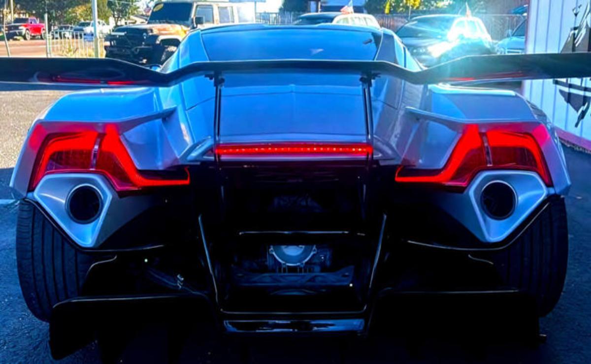 Rear view of a futuristic sports car with sleek angular taillights.