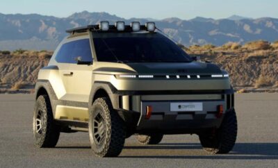 Sleek electric SUV with rugged off-road tires under a clear sky.