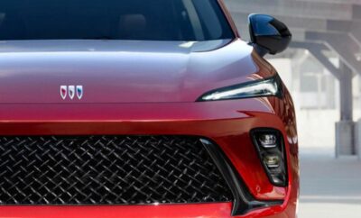 Close-up of a red car front with a sleek grille and headlights.