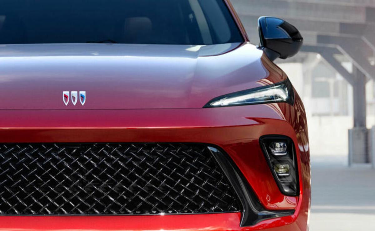 Close-up of a red car front with a sleek grille and headlights.