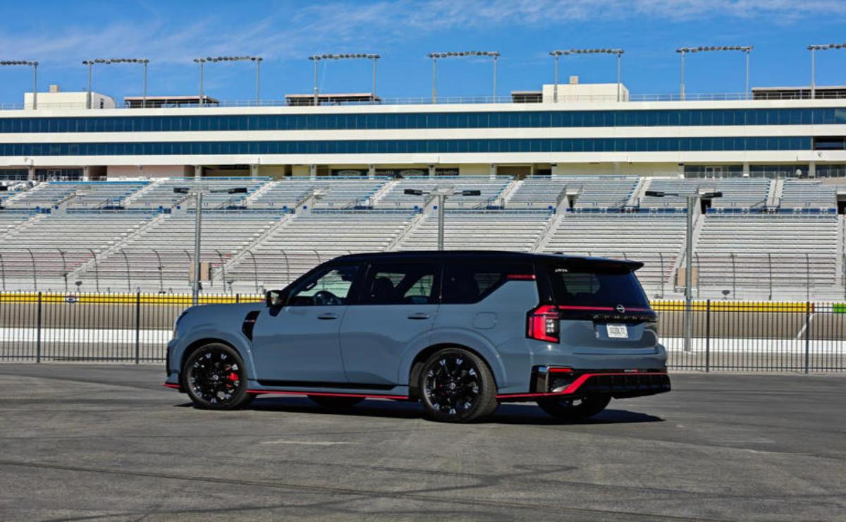 A sporty gray SUV with black and red accents parked on an empty race track.
