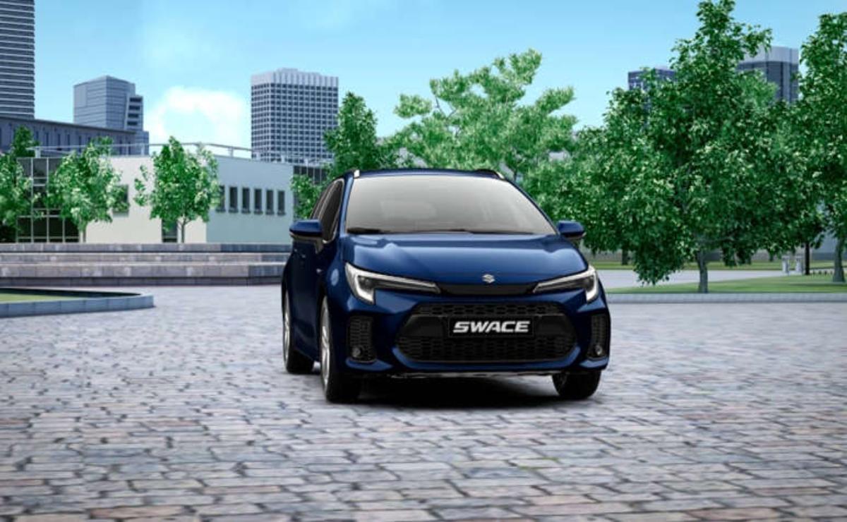 Black Suzuki Swift parked on cobblestone street with city buildings and greenery.
