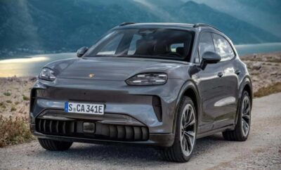 A sleek gray electric SUV parked with mountains in the background.