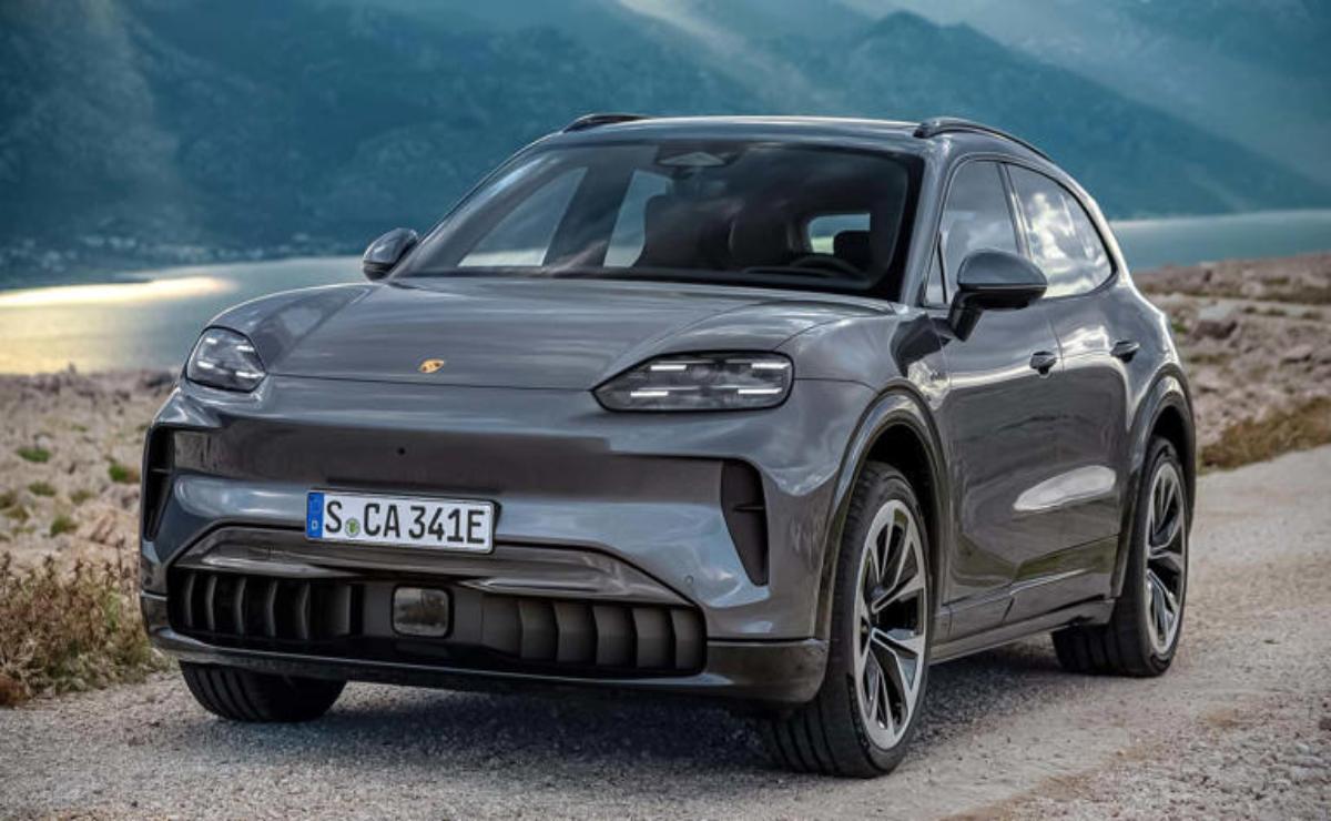 A sleek gray electric SUV parked with mountains in the background.