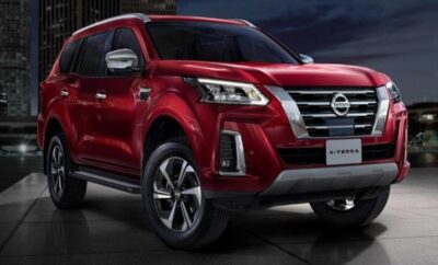 Red Nissan Pathfinder SUV showcased in a studio with dramatic lighting.