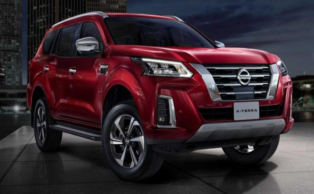Red Nissan Pathfinder SUV showcased in a studio with dramatic lighting.