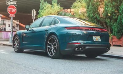 A sleek blue luxury sedan parked on a residential street.